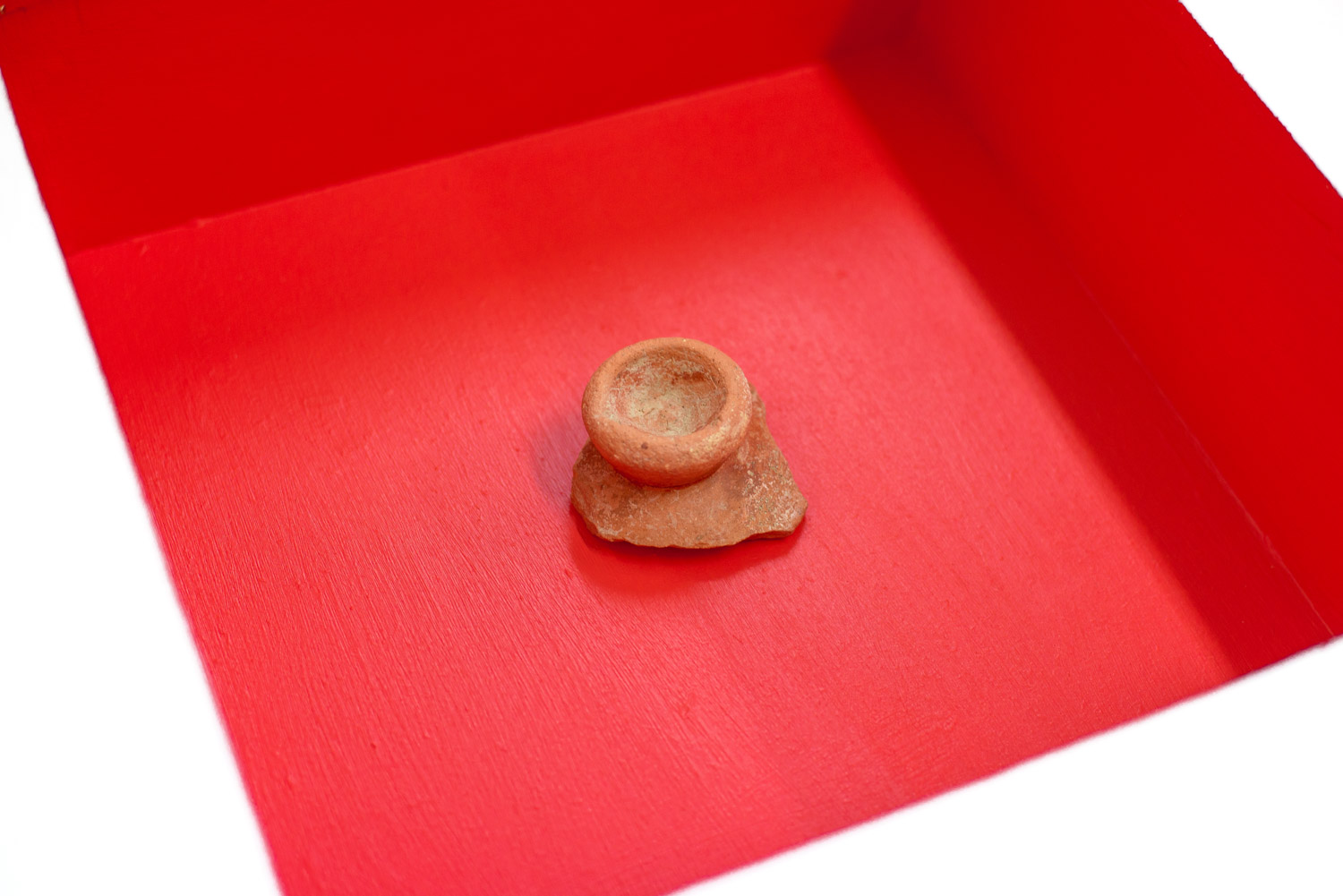 ceramic piece in a red box musuem